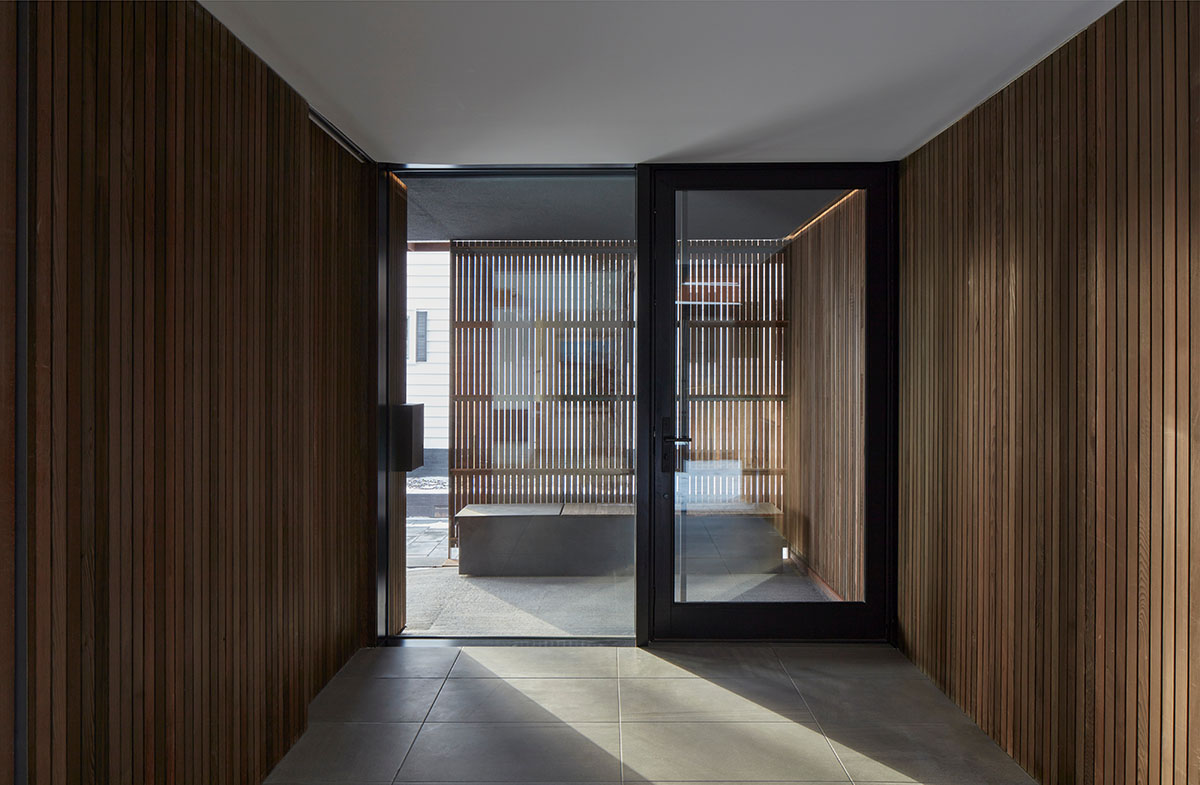 Weathered steel weil wraps the façade of Veil House in to resist snowfalls in Winnipeg