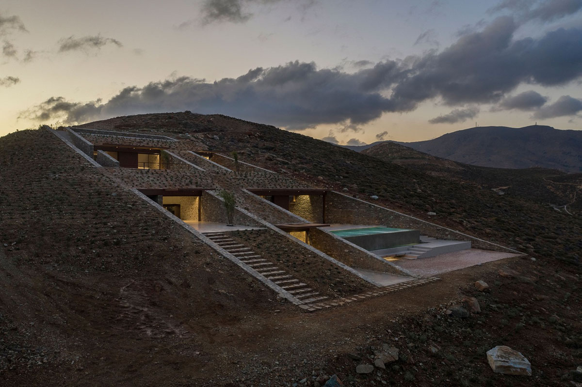 MOLD Architects used advantages of sloping land to design Ncaved house in Greece