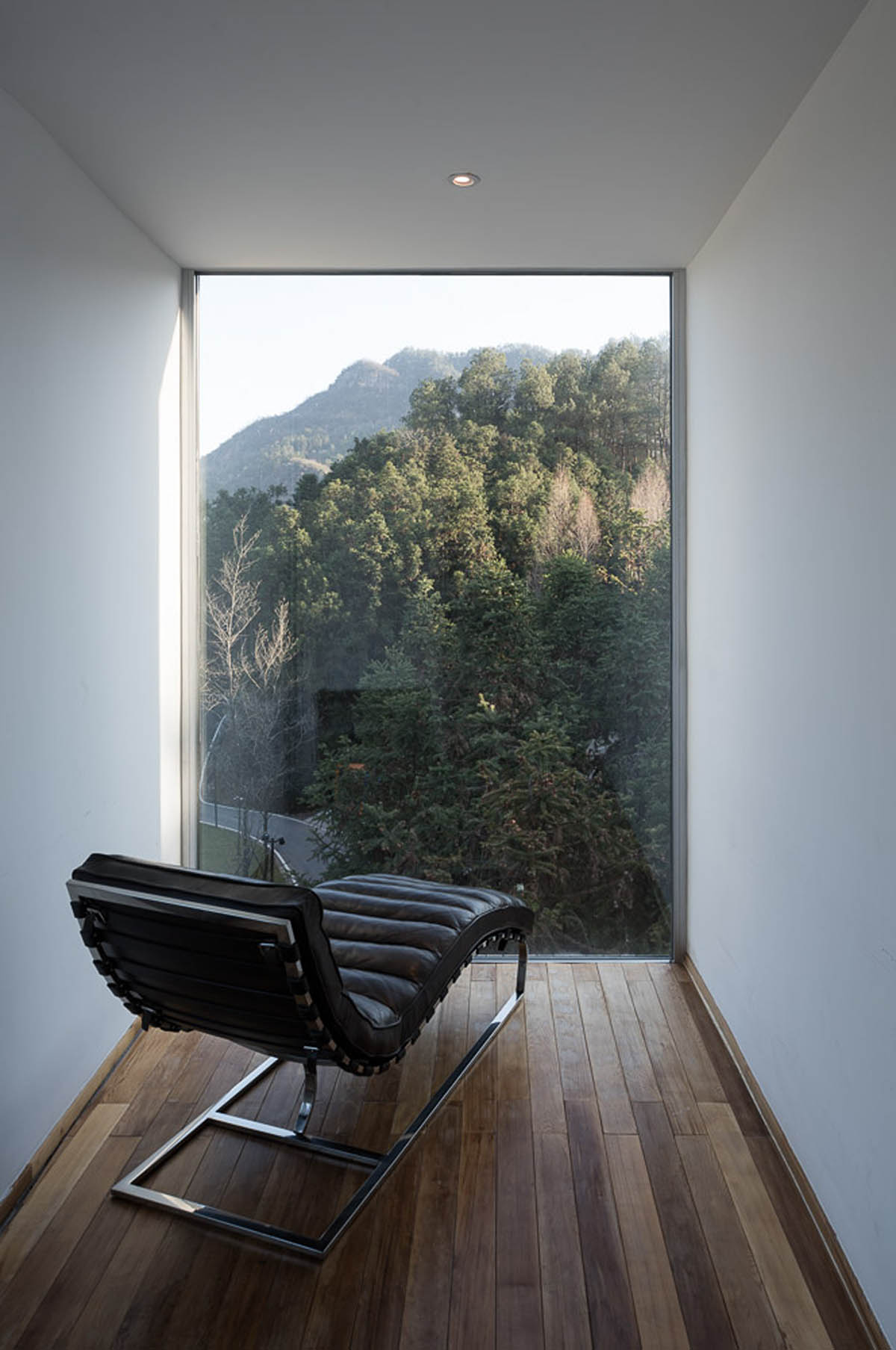 Bengo Studio joints multiple wooden rooms around a central staircase for Qiyun Mountain Tree Hotel