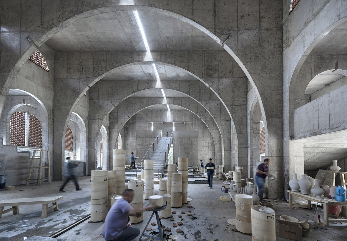 AZL Architects renovates old kiln building with concrete and brick arches in the middle of a forest