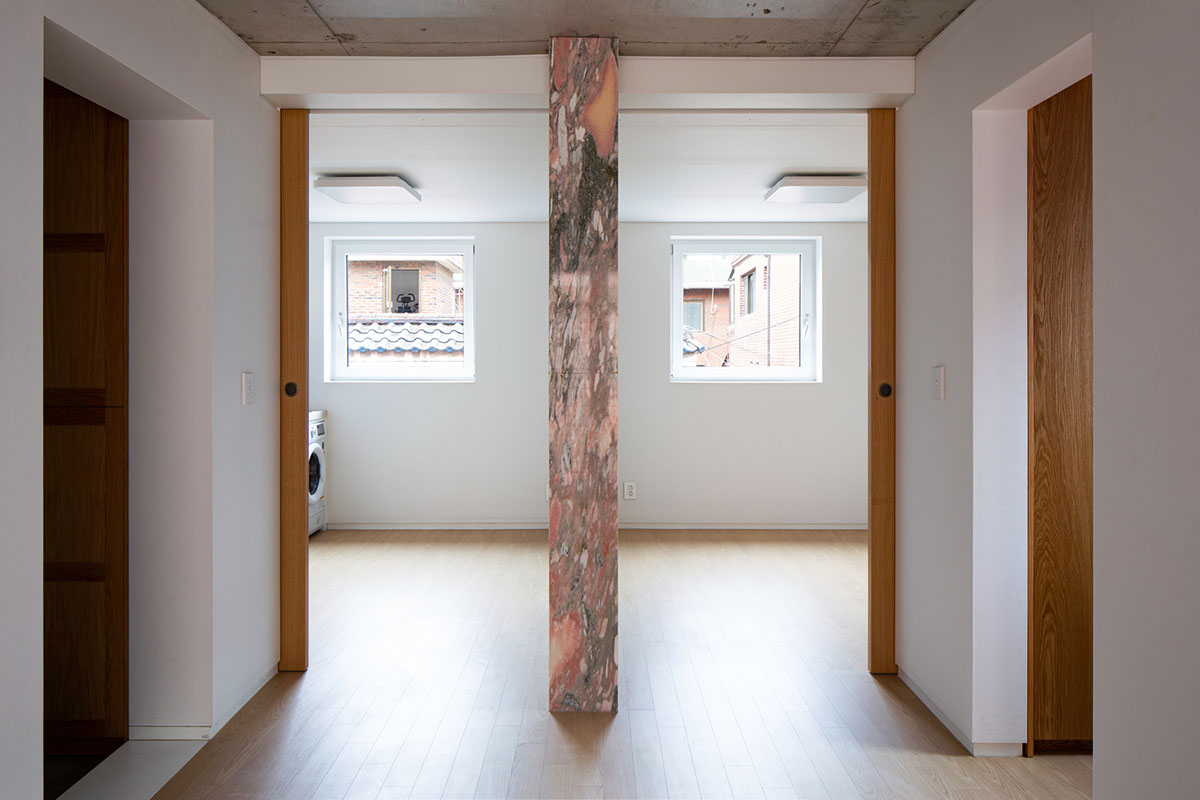 aoa architects uses red marble tiles to clad this apartment in South Korean neighborhood