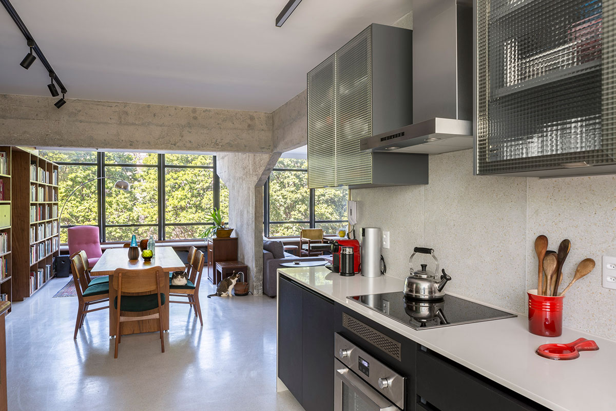 A historic Brazilian apartment has been redesigned with wooden bookcase as main divider