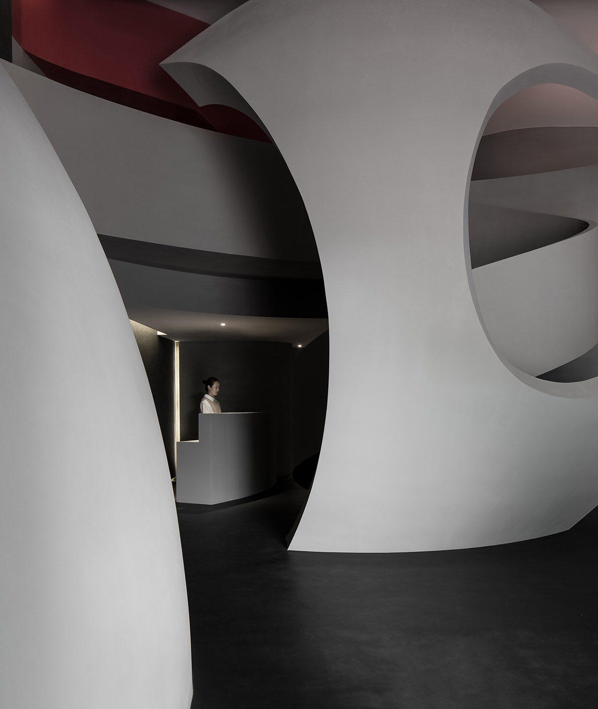 A beauty salon by AD ARCHITECTURE features dark-hued interiors drawing inspiration from cells