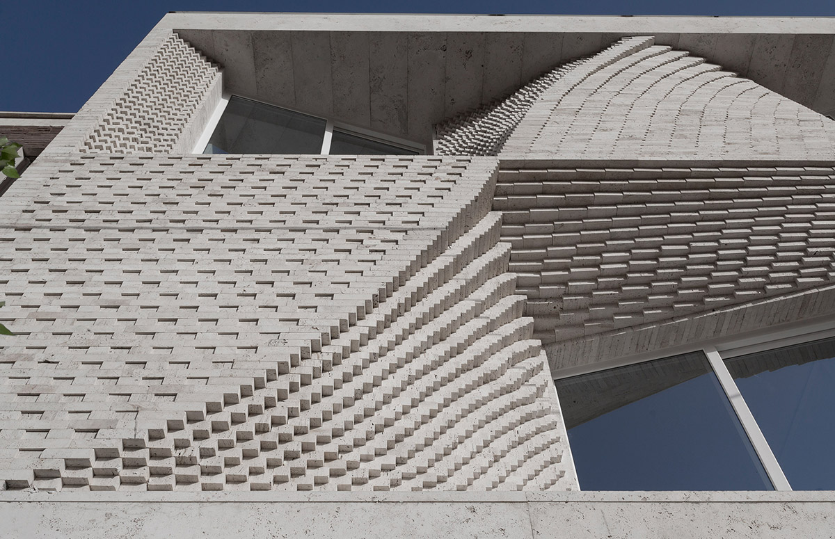 CAAT Studio creates spatial variations of stone on the facade of this Iranian residential building