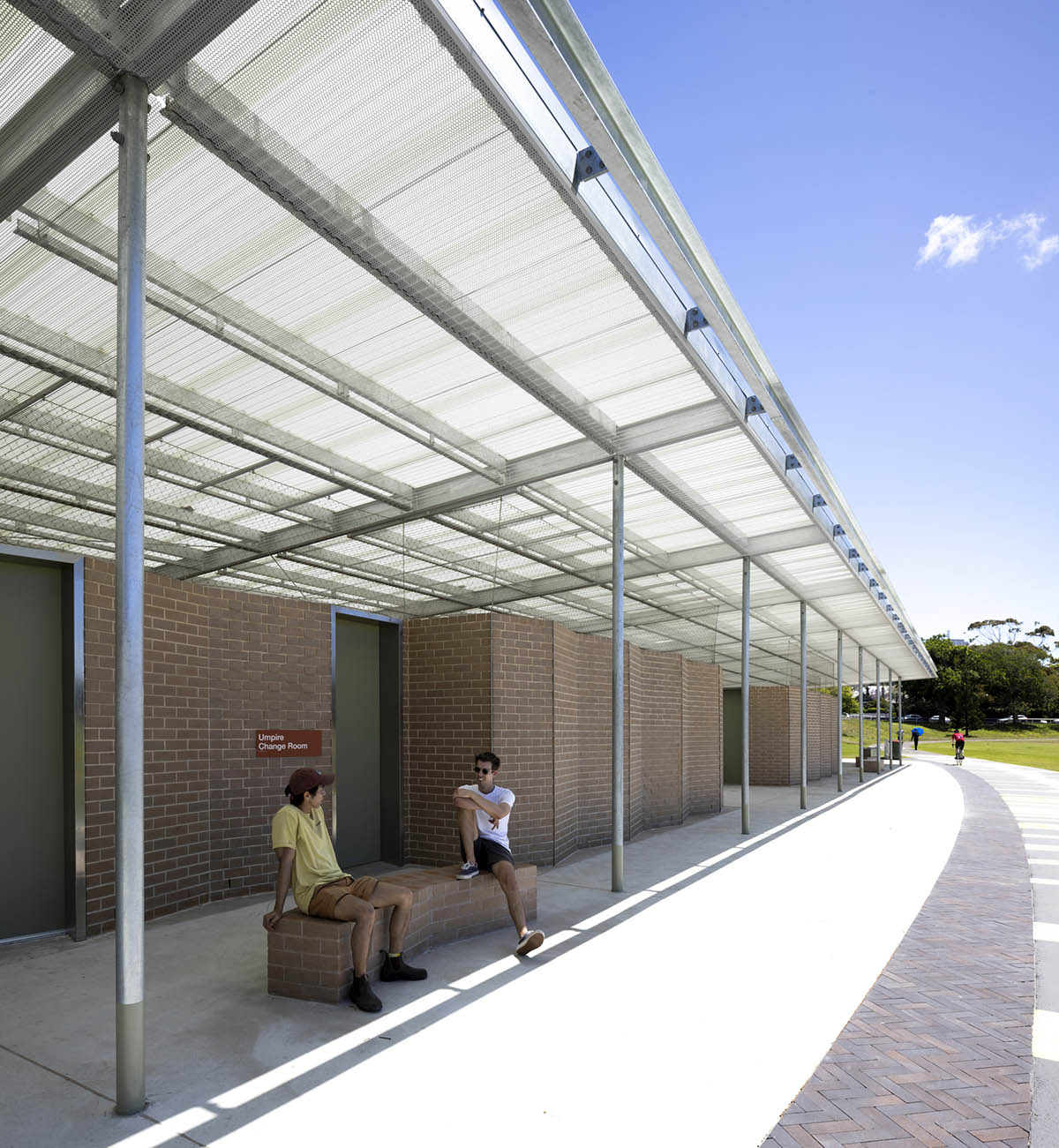 Sports pavilion is made of zigzagging brick walls referencing serrated leaves of endangered banksia