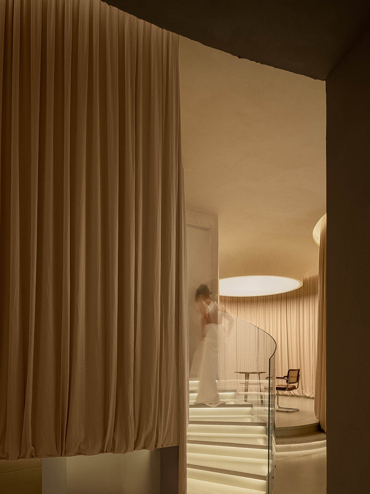 Tea house interiors wrapped by earth-toned fabric curtains act like 