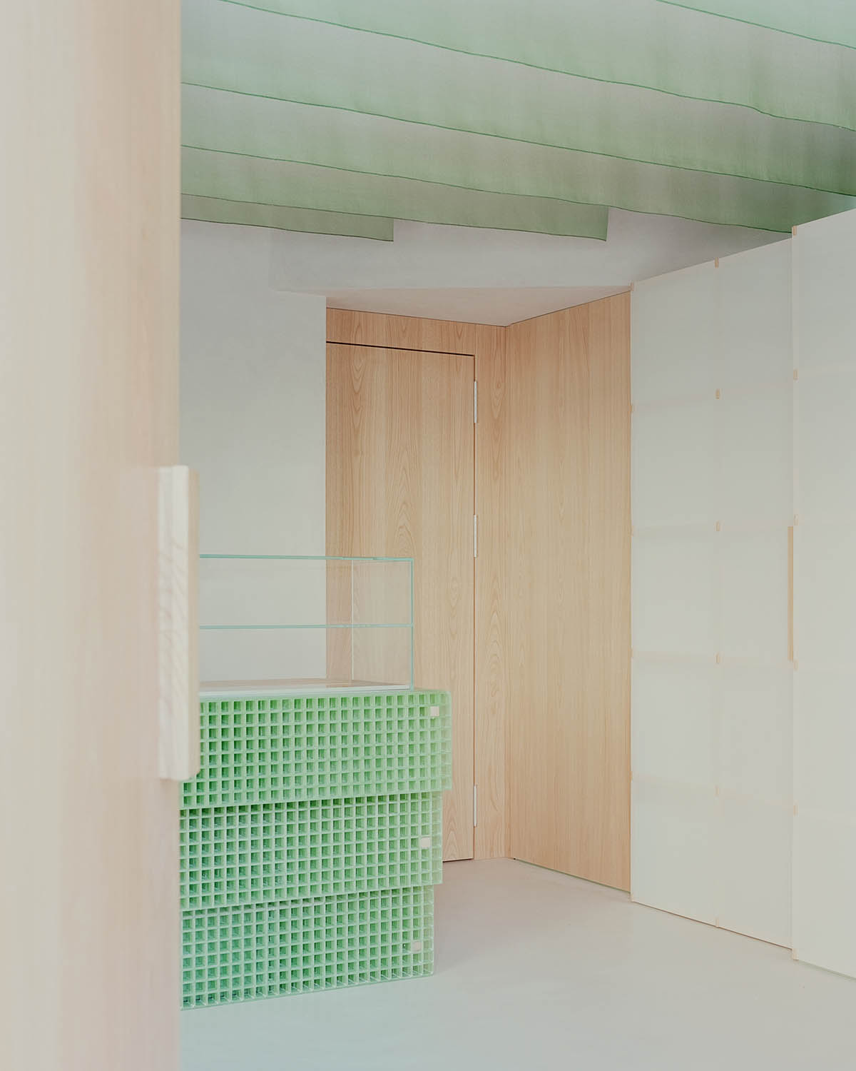 studio wok adds soft green tones and powder colors to interiors of a bakery in Milan 