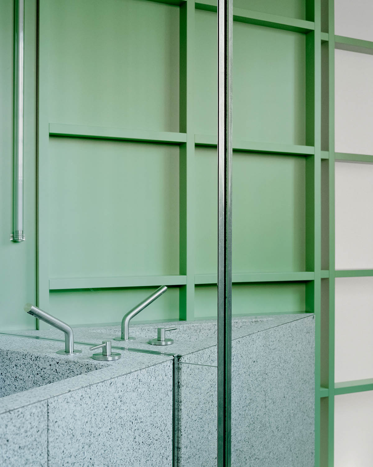 studio wok adds soft green tones and powder colors to interiors of a bakery in Milan 