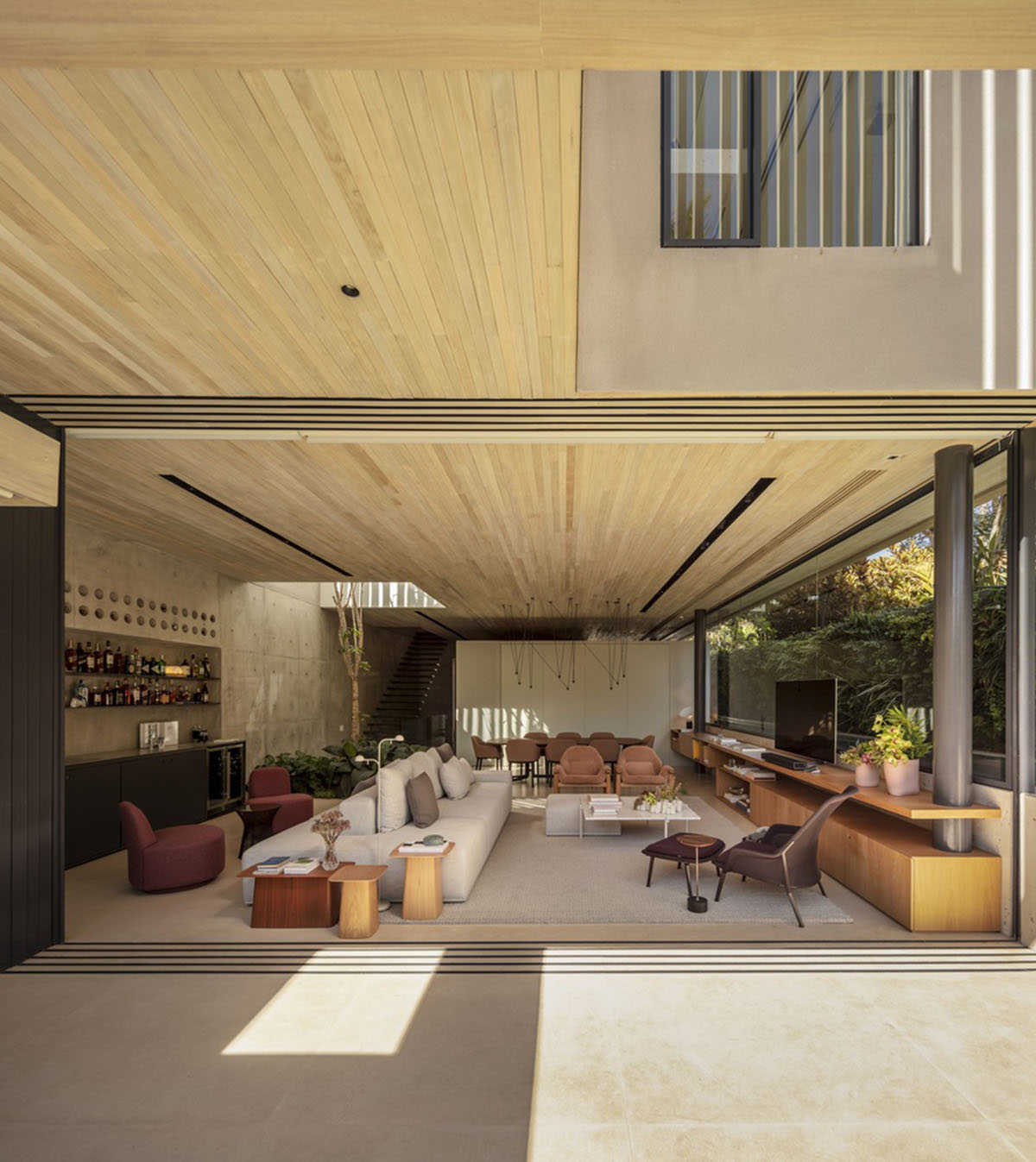 Studio AG designed large wooden residence featuring punctured volumes with gabled roof in São Paulo