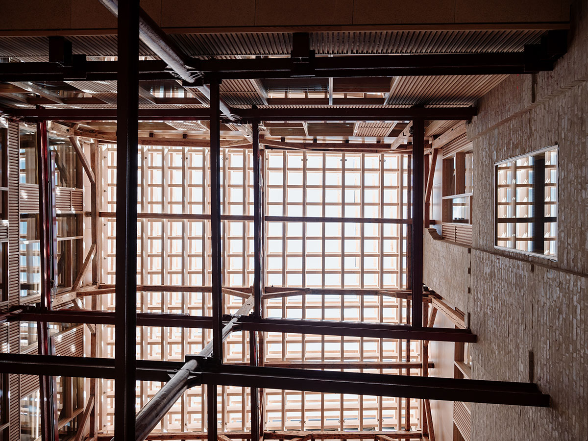 Atelier Oslo and KIMA Arkitektur restore former warehouse as a press house with light-lit atrium