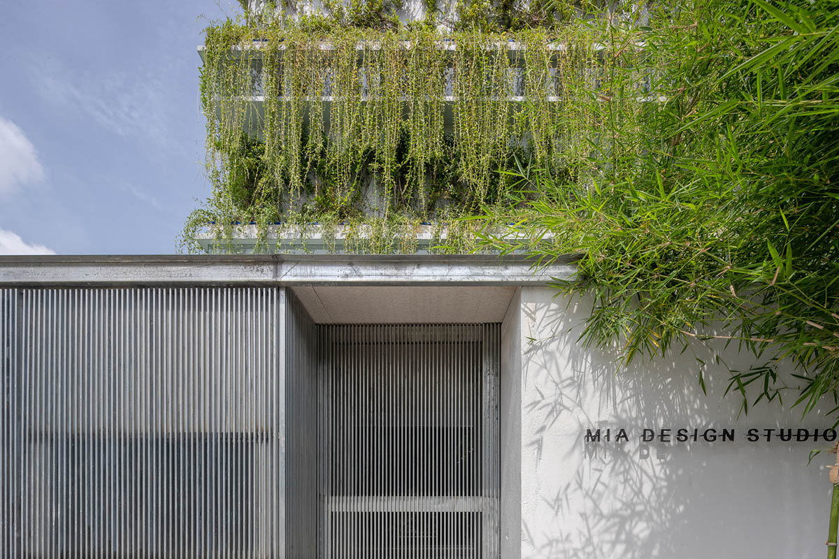 MIA Design Studio created vertical open library inside its office filled with greenery in Vietnam