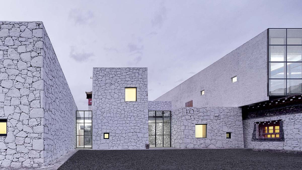 Jí Architects extends Tsenpo Museum with floating glass box overlooking snow mountains in China