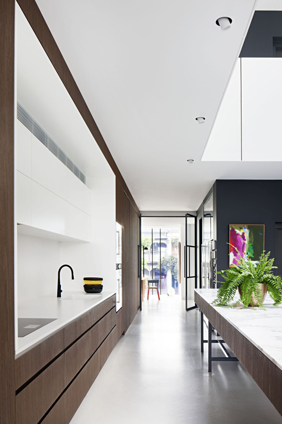 Protruding glass boxes form mixed-use housing in a narrow plot in Melbourne