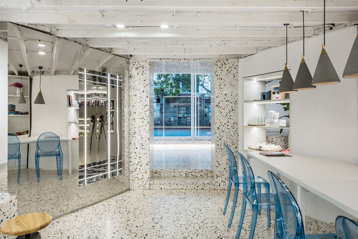 This tiny cafe by TOUCH Design is dotted with white and orange interwoven terrazzo details in Tianjin