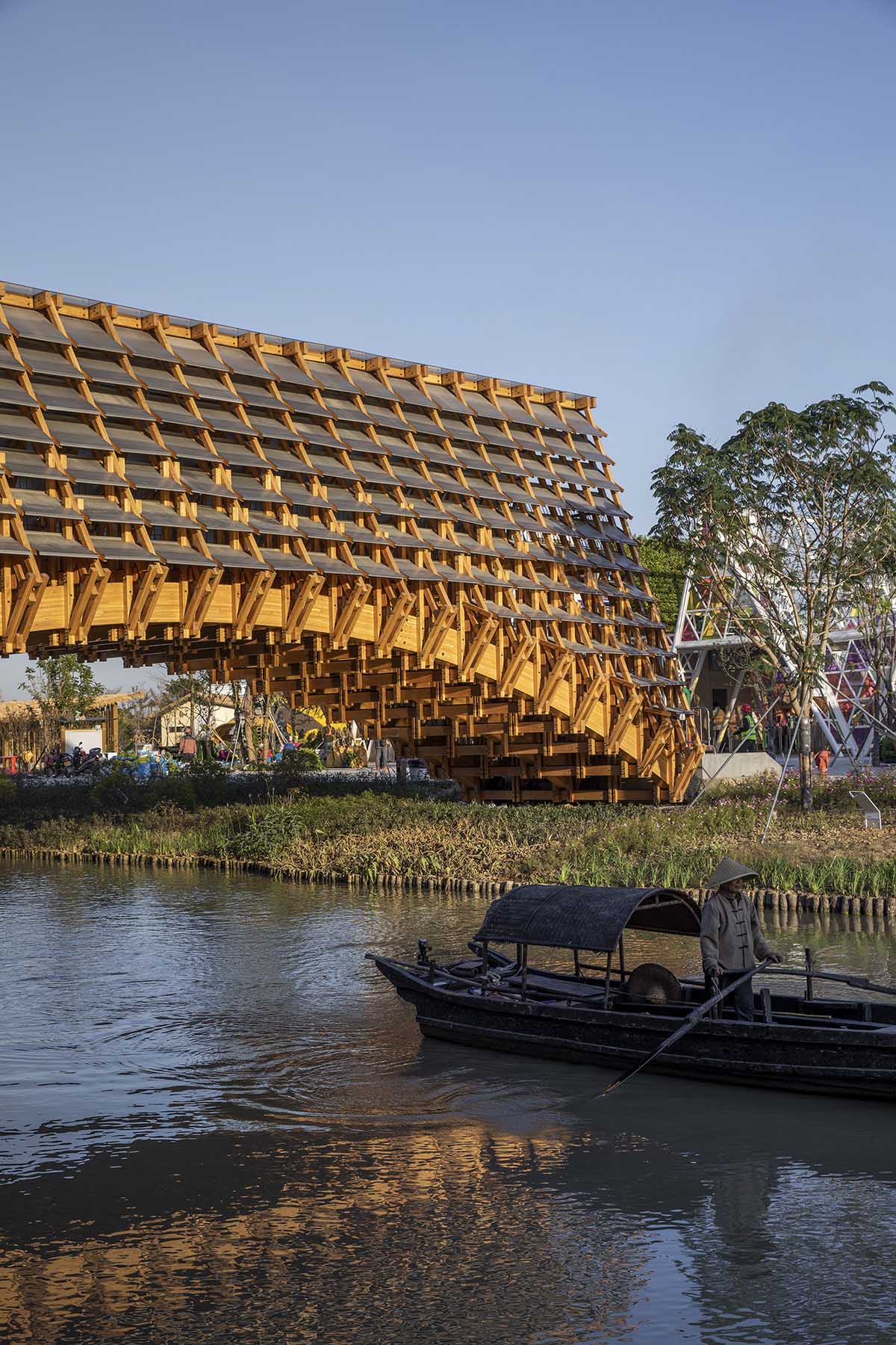 Arched timber bridge by LUO studio allows boats to pass under bridge ...