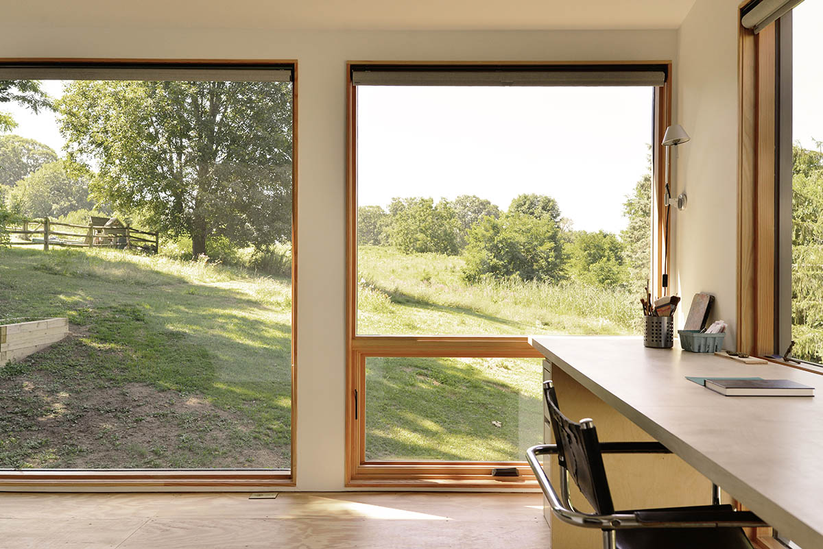 An artist's studio floats and illuminates in the landscape in Germantown