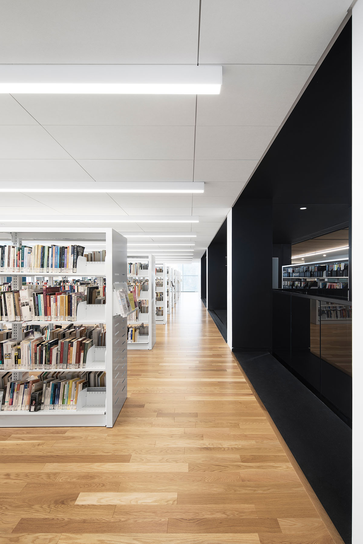 Whitish glass library designed by ACDF Architecture acts as a white floating volume in Quebec