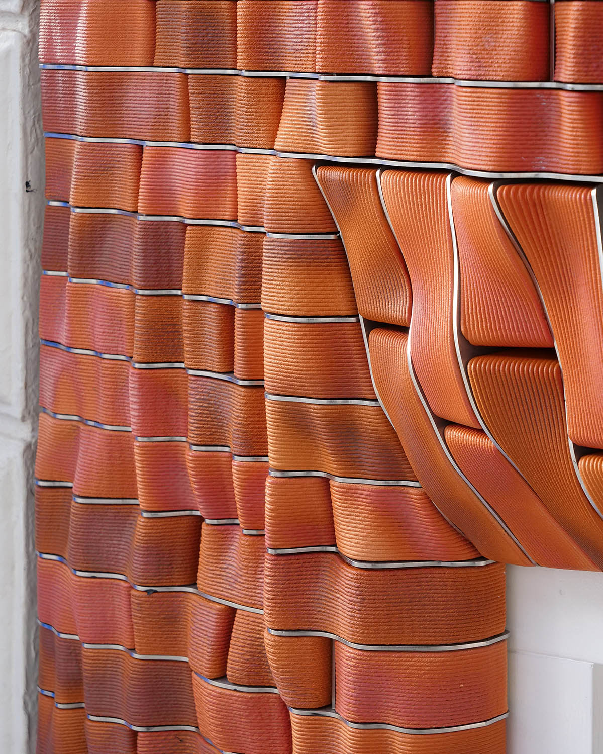 Studio RAP creates façade featuring bespoke 3D-printed ceramic tiles and bricks