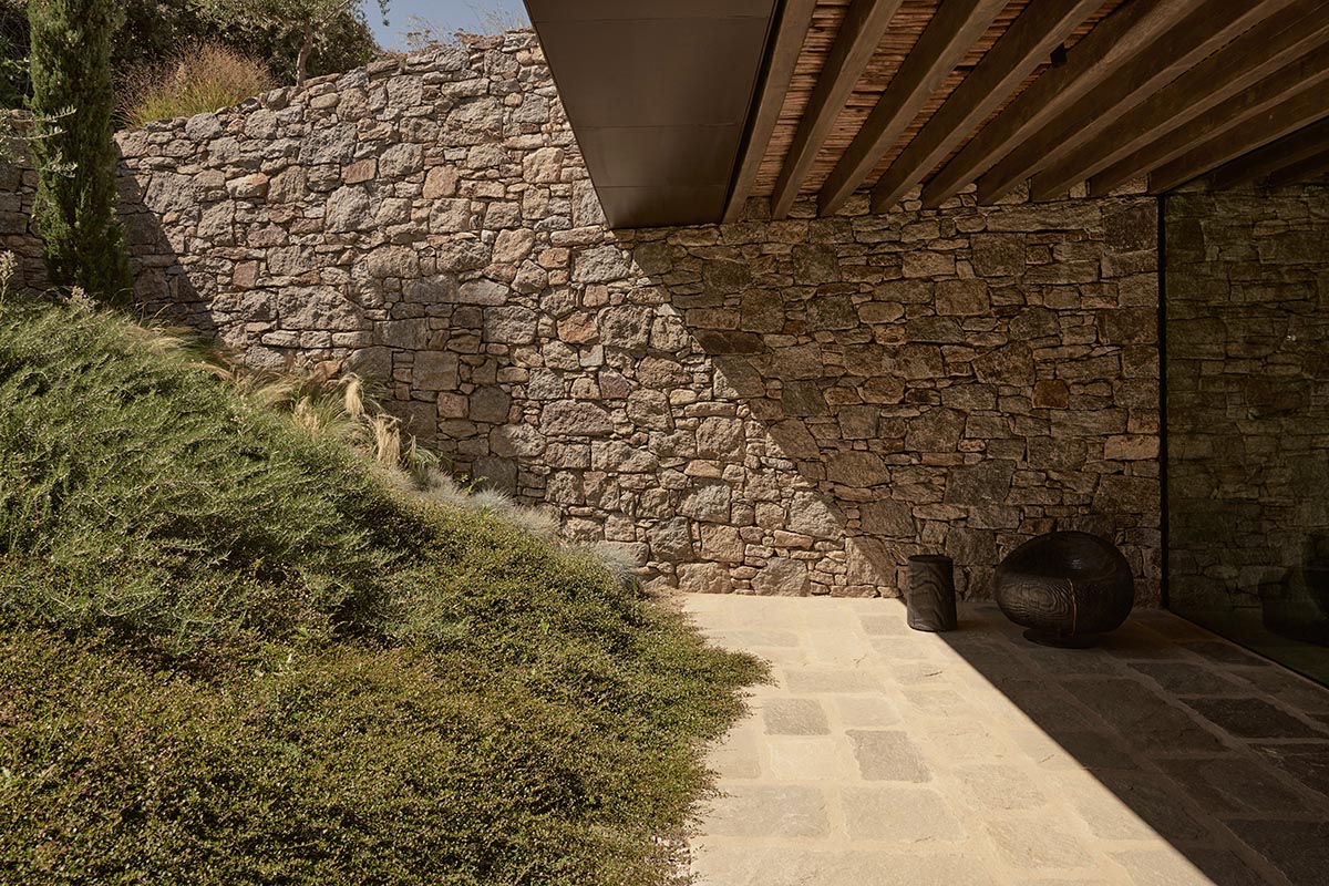 Terraced stonewalls sprawl down to offer an exploratory route in an old vineyard in Samos