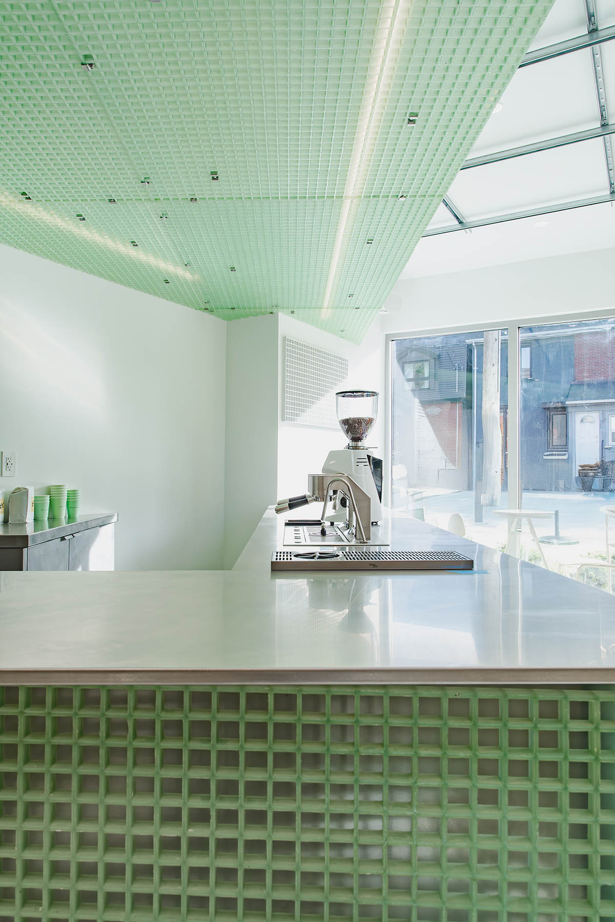 Misc Coffee makes a bold statement with green translucent bar in a busy street of Toronto