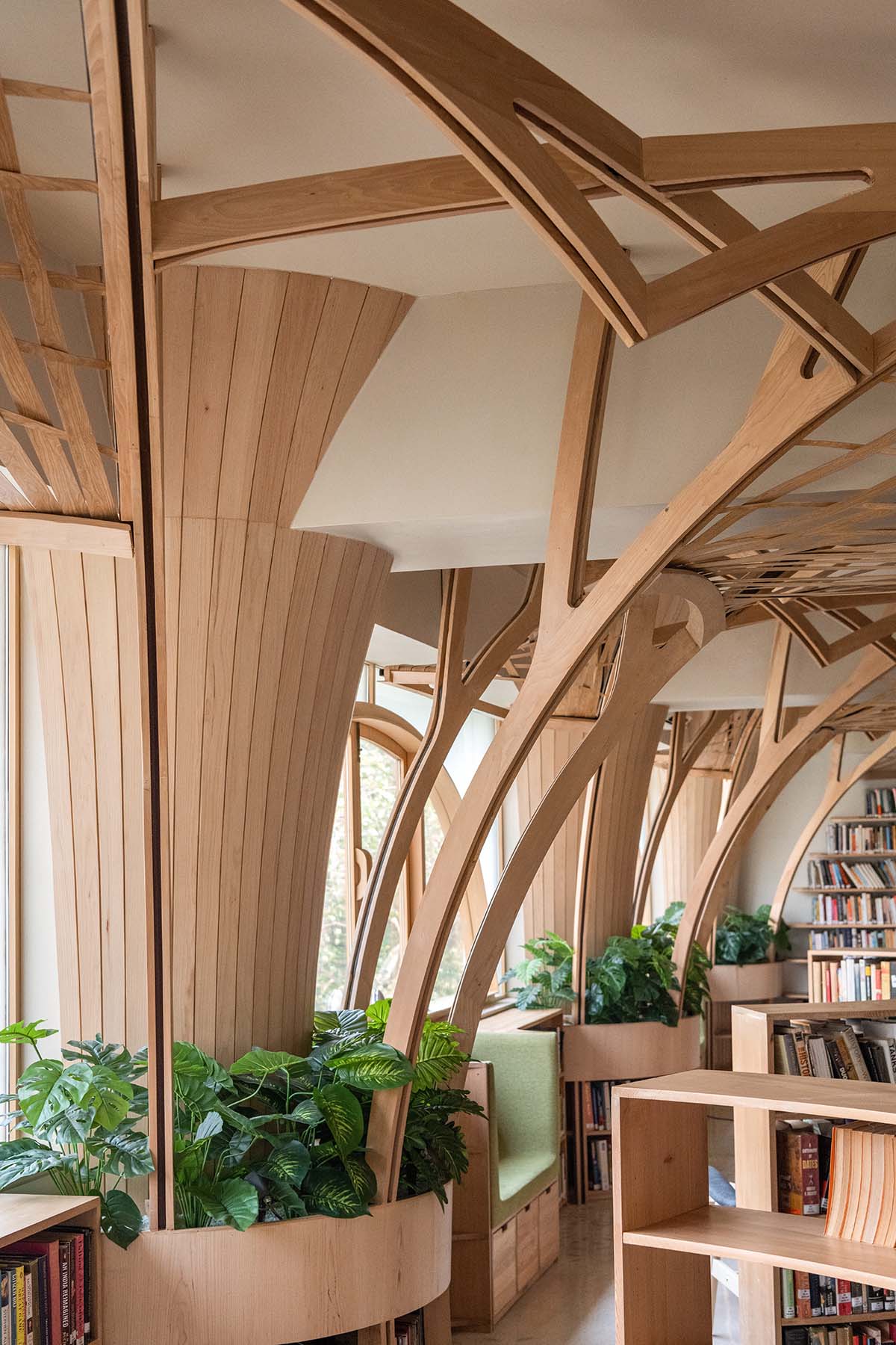 studio Hinge embeds a library under the wooden tree-like canopies in Mumbai