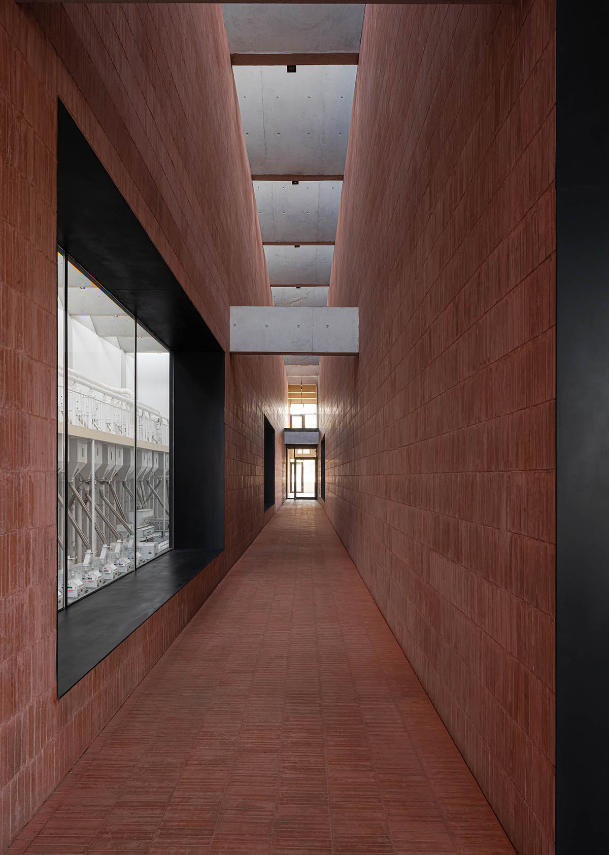 Grey brick walls wrap a factory building referencing to local construction methods in China 