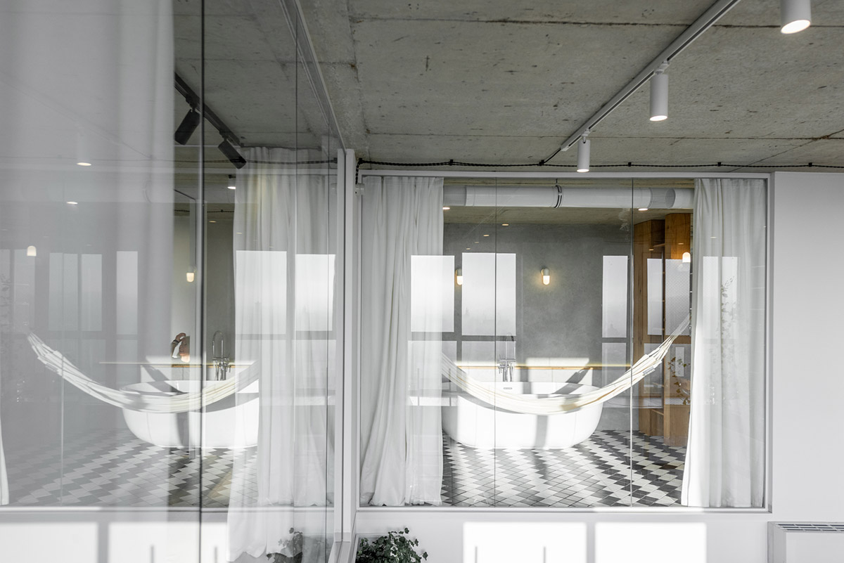 Metal framed-table, glass partitions, green infills make this interior space vivid and light in Lviv