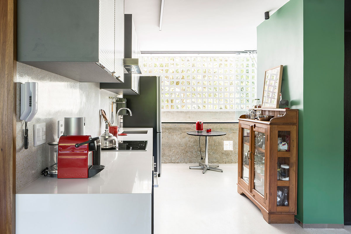 A historic Brazilian apartment has been redesigned with wooden bookcase as main divider