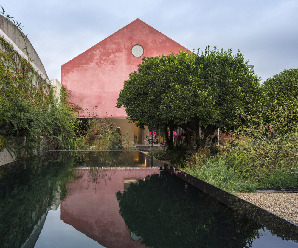 Extrastudio converted former winery in Portugal  into a new family home with red mortar walls