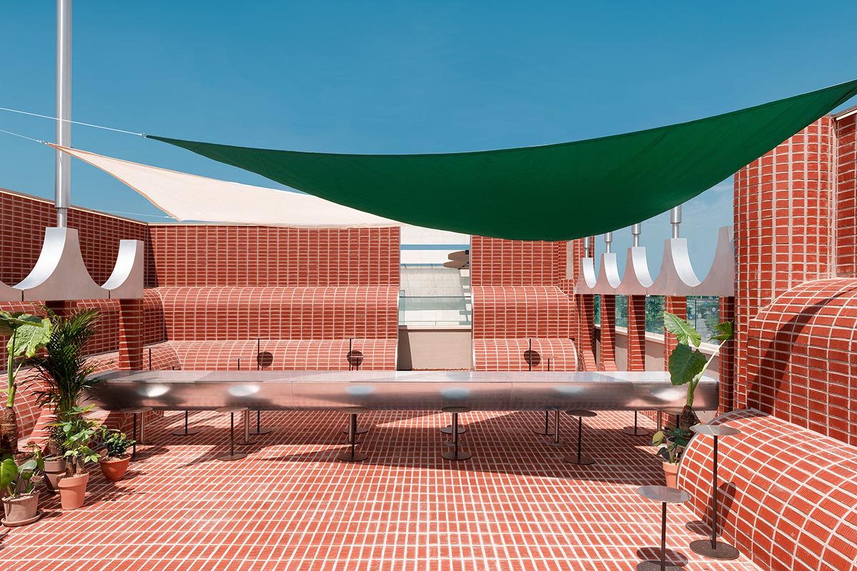 Bakery cafe by sukchulmok features bold red brick tiles and rounded walls evoking 