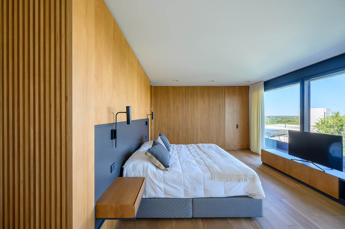 AR Arquitectos completes family home with black concrete and wooden cladding in Argentina 