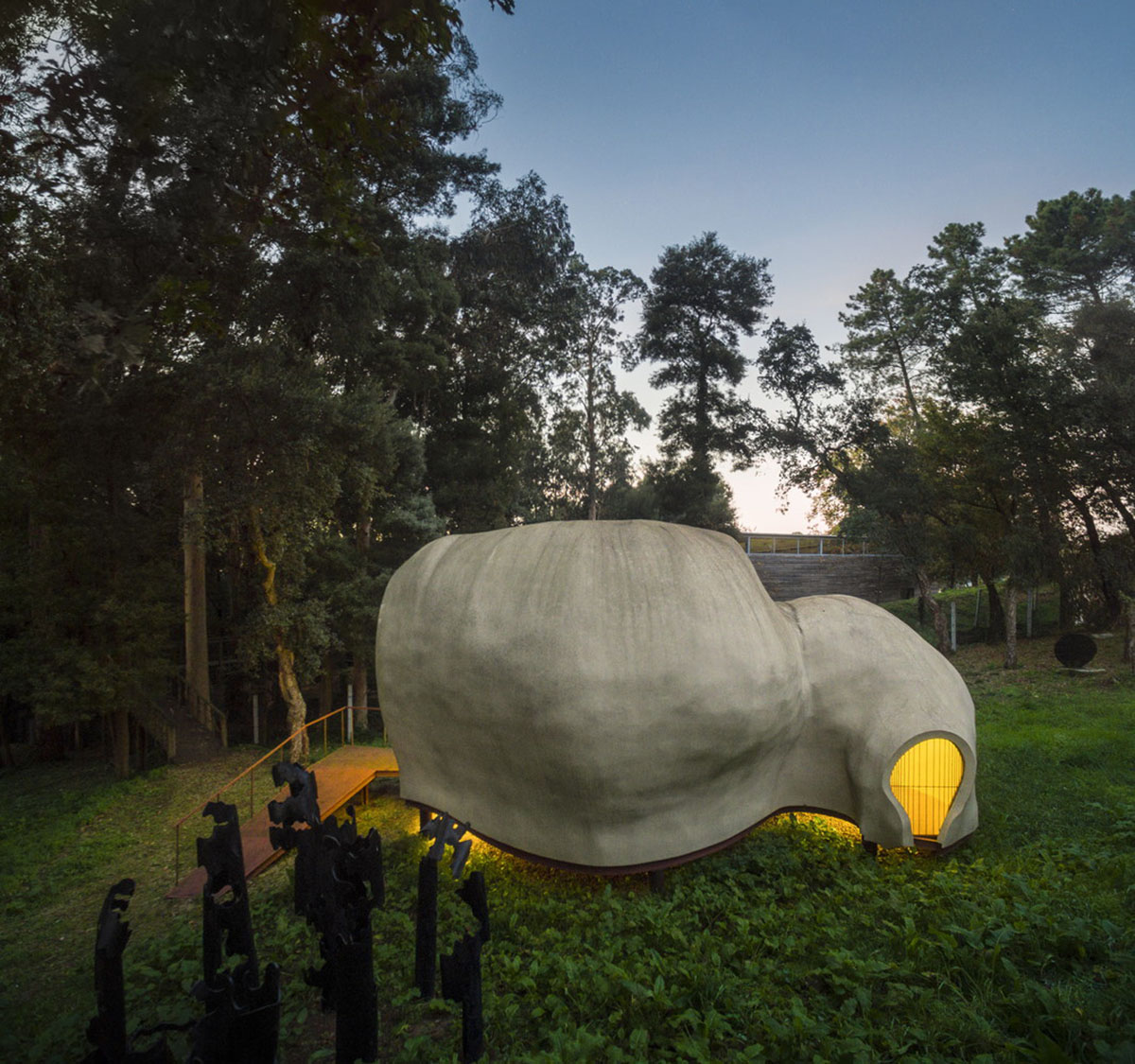 Super small cave-like art gallery by FCC Arquitectura built on lush green in Portugal
