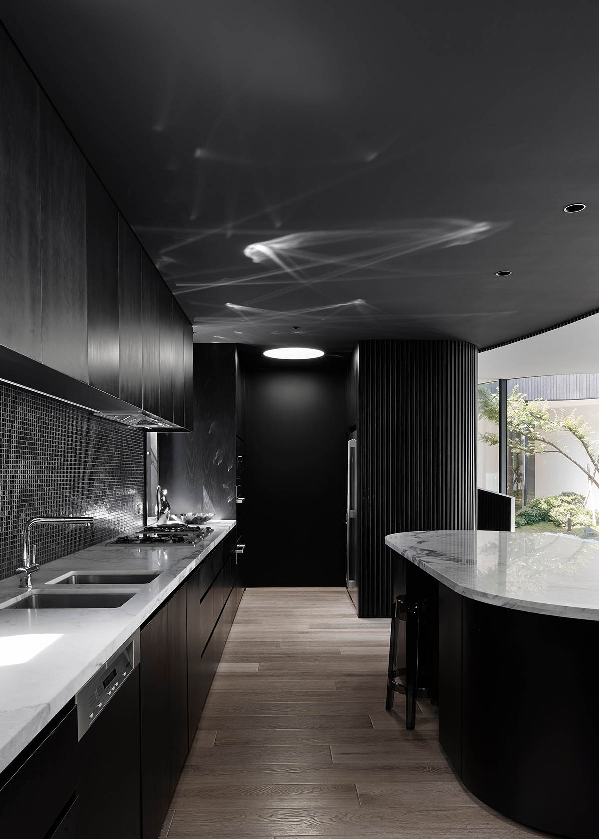 Wood Marsh built curvaceous home clad in dark timber contrasting its natural landscape in Portsea