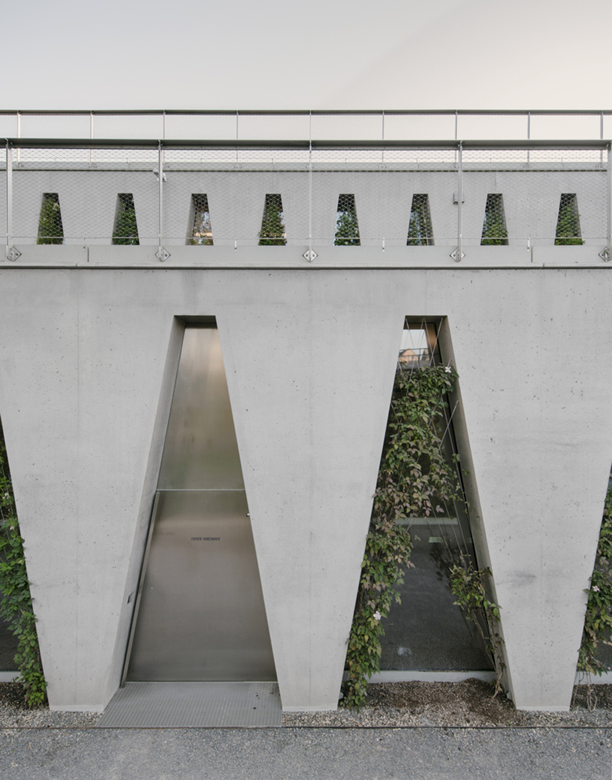 Trapezoidal openings characterize the interiors of cultural center by Estudio Barozzi Veiga in Zürich