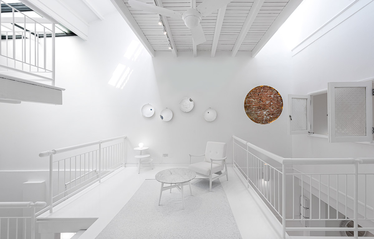 Ministry of Design transforms old dwelling in Singapore into co-living house with all-white interiors