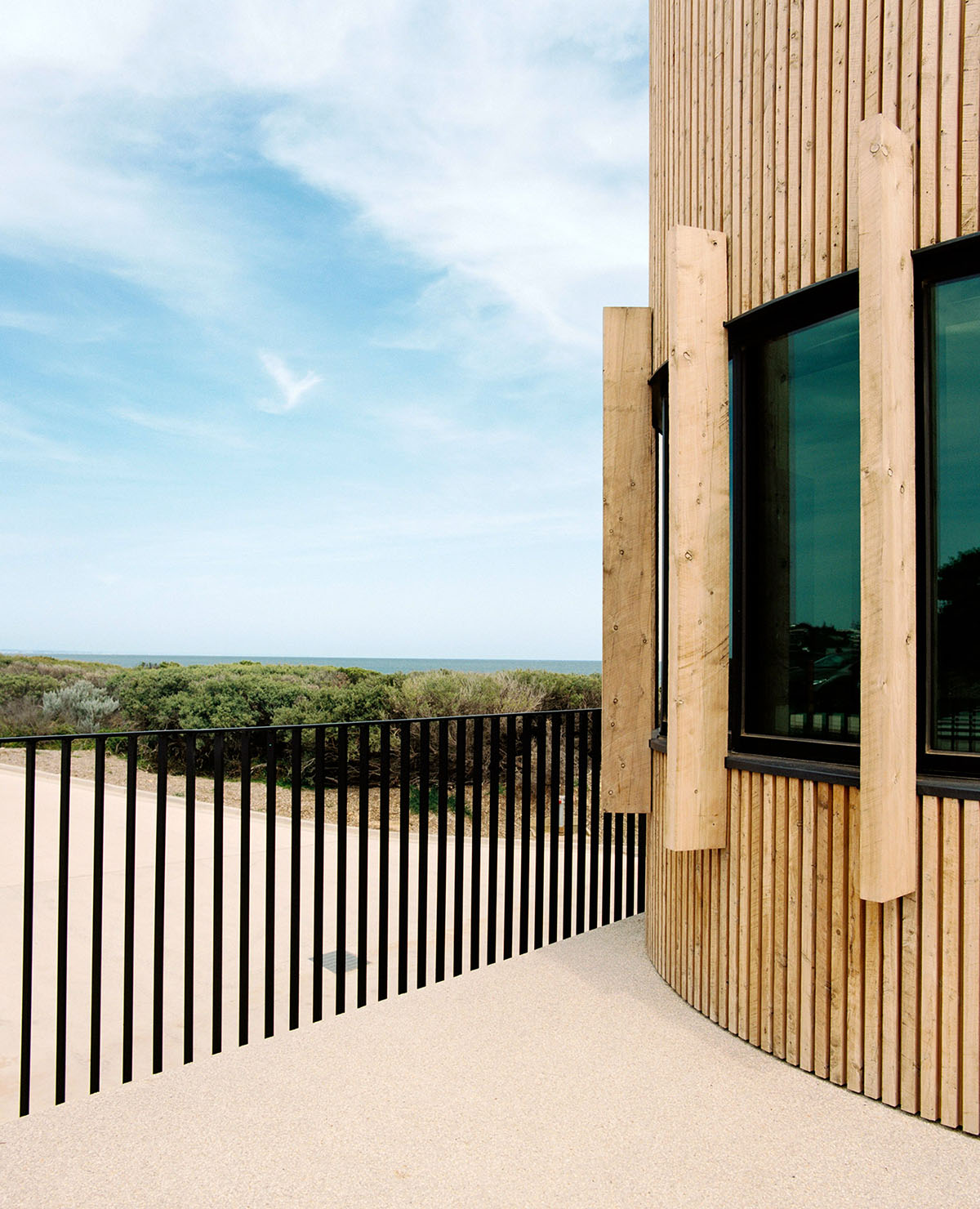 Wood Marsh completes surf club with timber rounded corners echoing ocean and eroded dunes