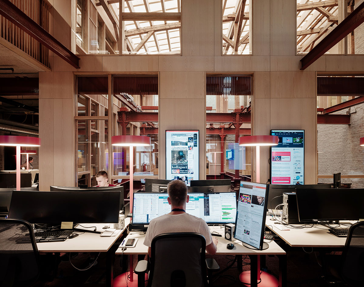 Atelier Oslo and KIMA Arkitektur restore former warehouse as a press house with light-lit atrium