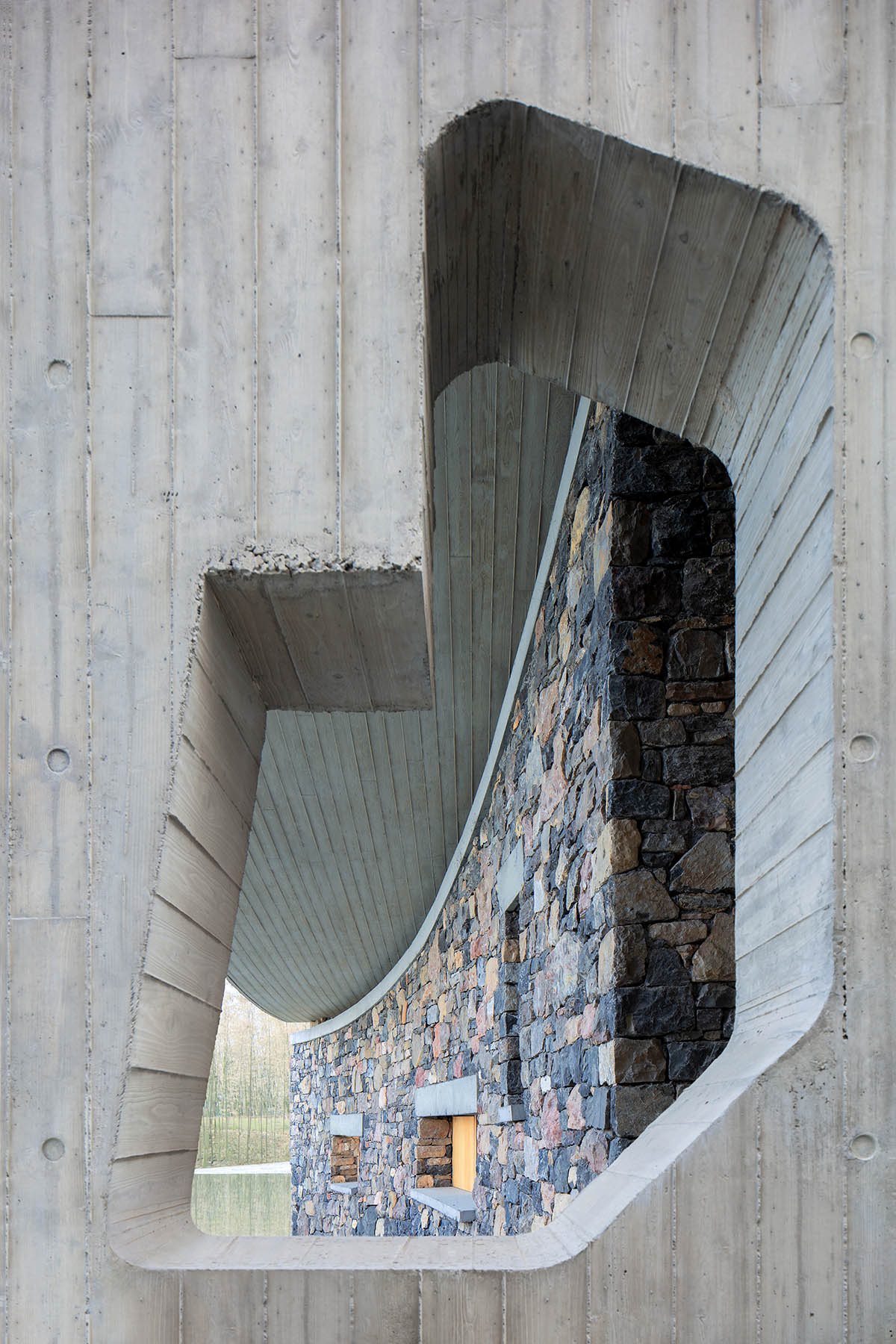 Concrete hyperboloid roofs cover masonry stone art center with a central courtyard in Shandong