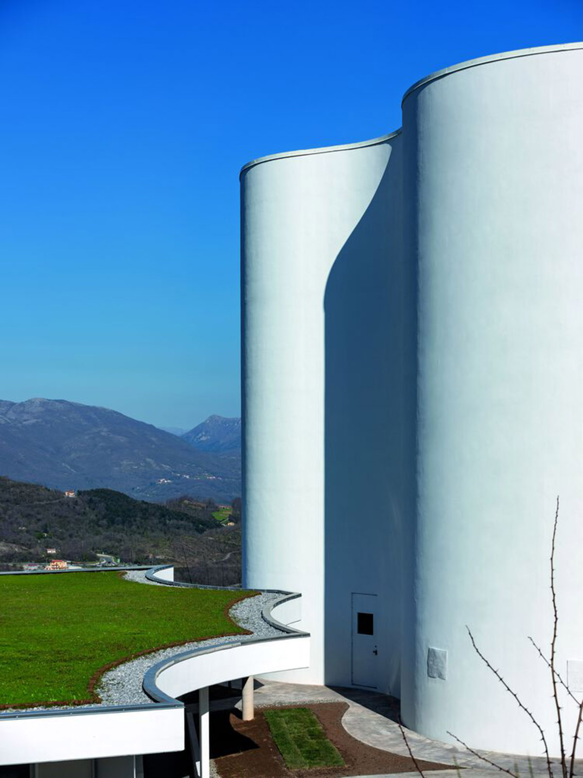 Smooth all-white walls form church designed by Mario Cucinella Architects in Mormanno hill town 
