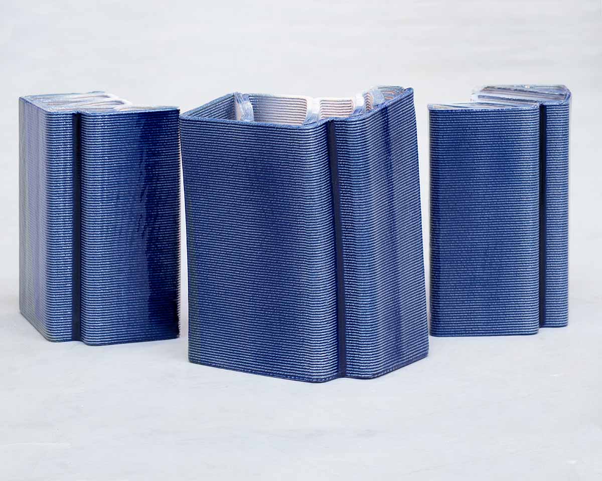 Studio RAP clads two gates of PoortMeesters residential building block in 3D blue porcelain