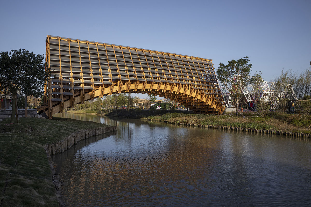 Arched timber bridge by LUO studio allows boats to pass under bridge smoothly in Gulou waterfront