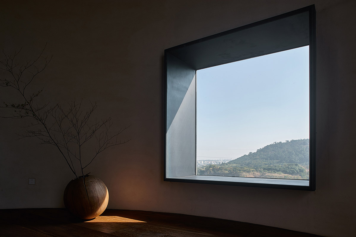 ZMY Design creates earth-toned interiors for a woodwork enthusiast’s house in Fujian, China