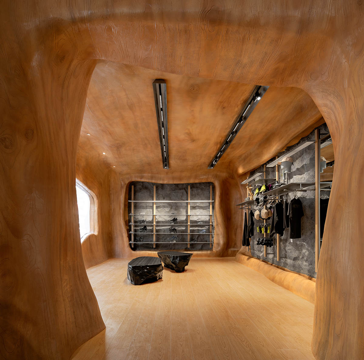 STILL YOUNG creates cave-like interiors for a store with wood and rock elements in Beijing 