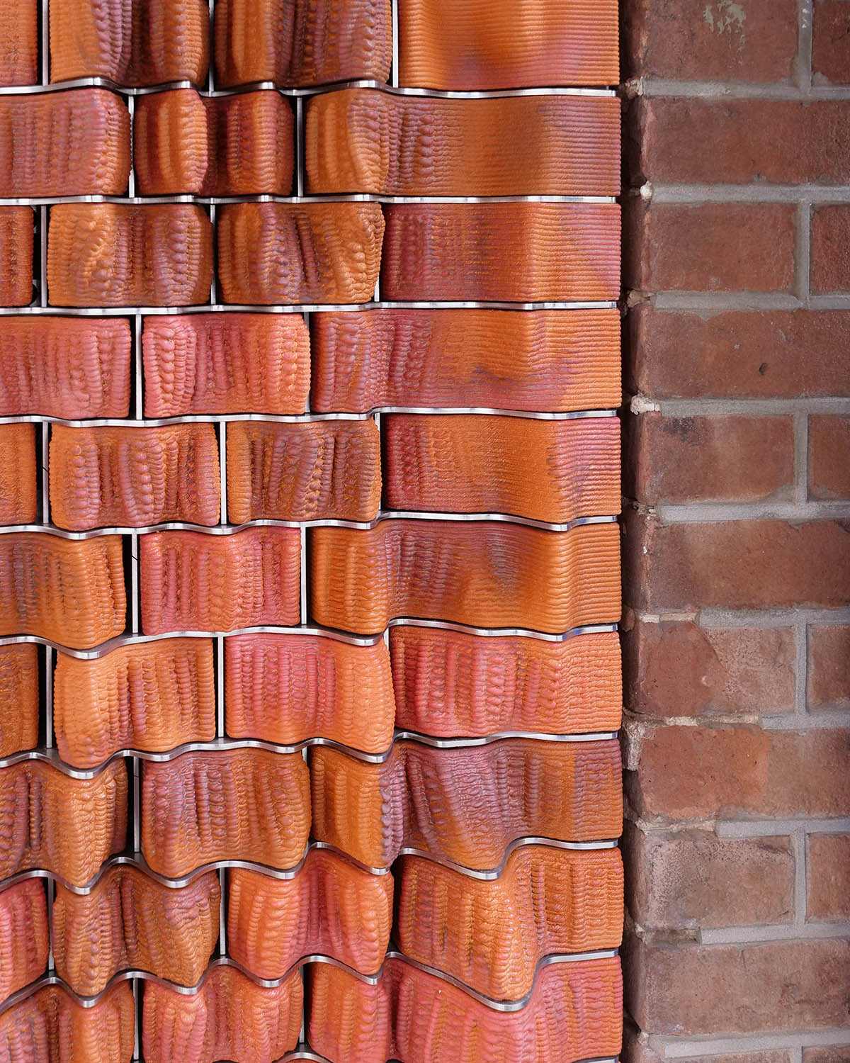 Studio RAP creates façade featuring bespoke 3D-printed ceramic tiles and bricks