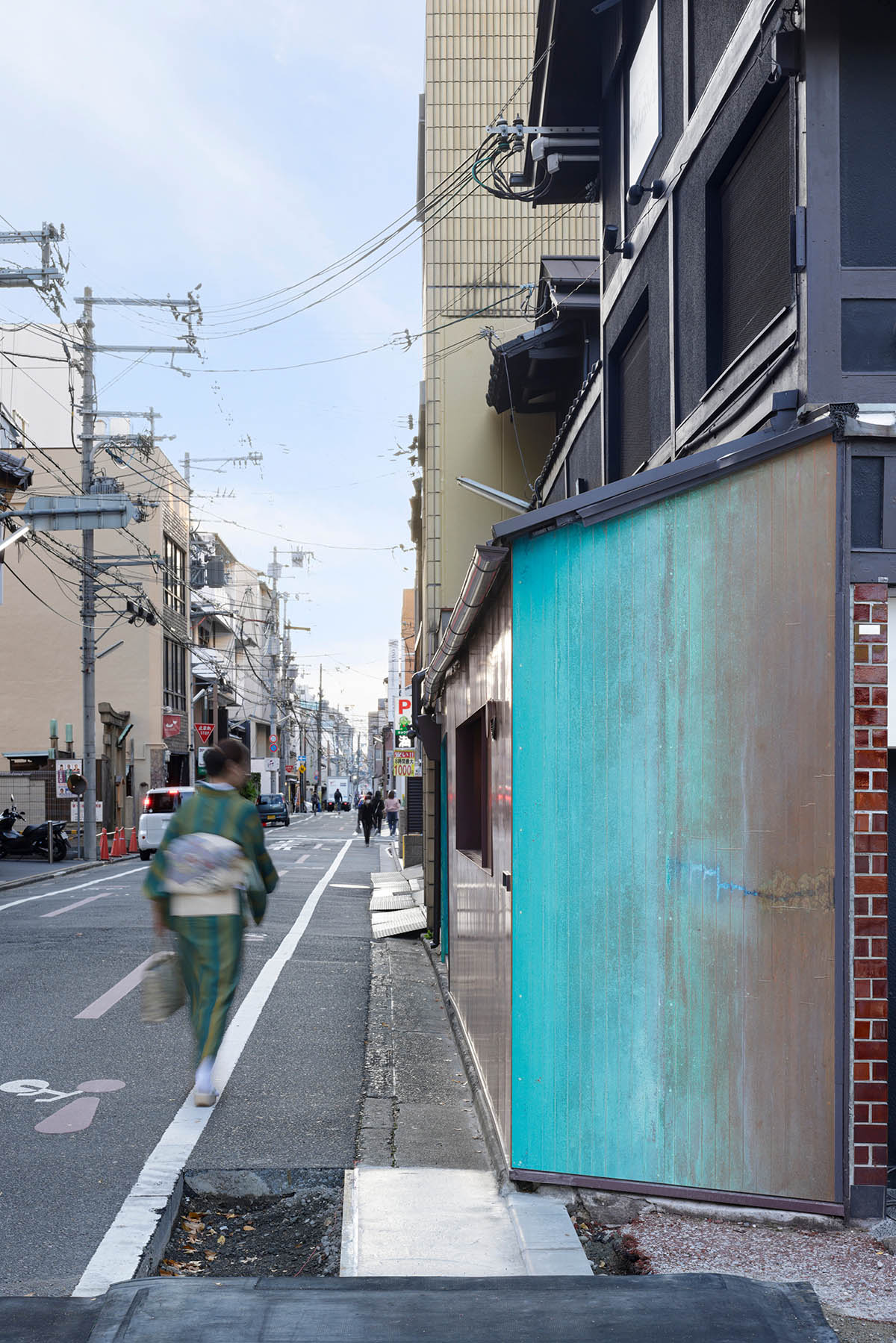 The one-meter-deep cafe invites customers with its patina color on its facade in Kyoto