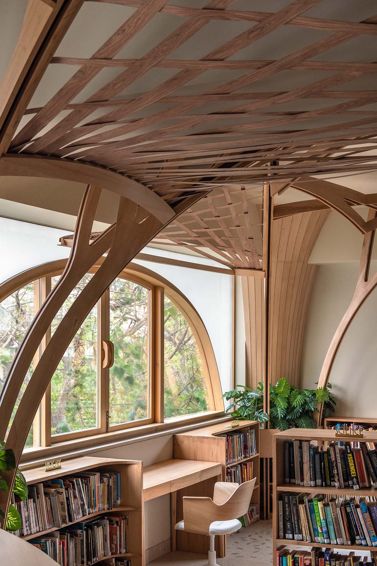 studio Hinge embeds a library under the wooden tree-like canopies in Mumbai