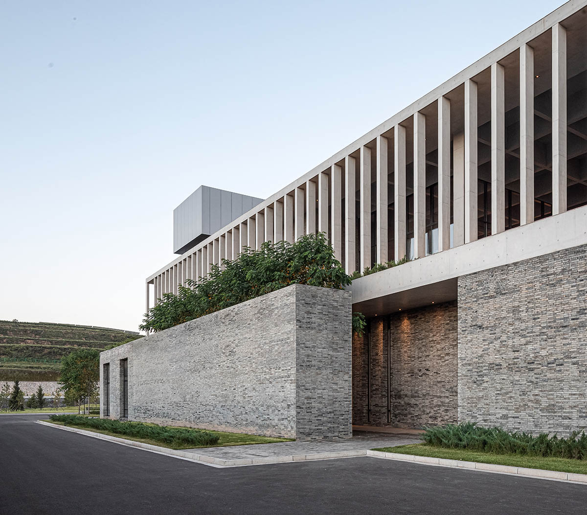 Grey brick walls wrap a factory building referencing to local construction methods in China 