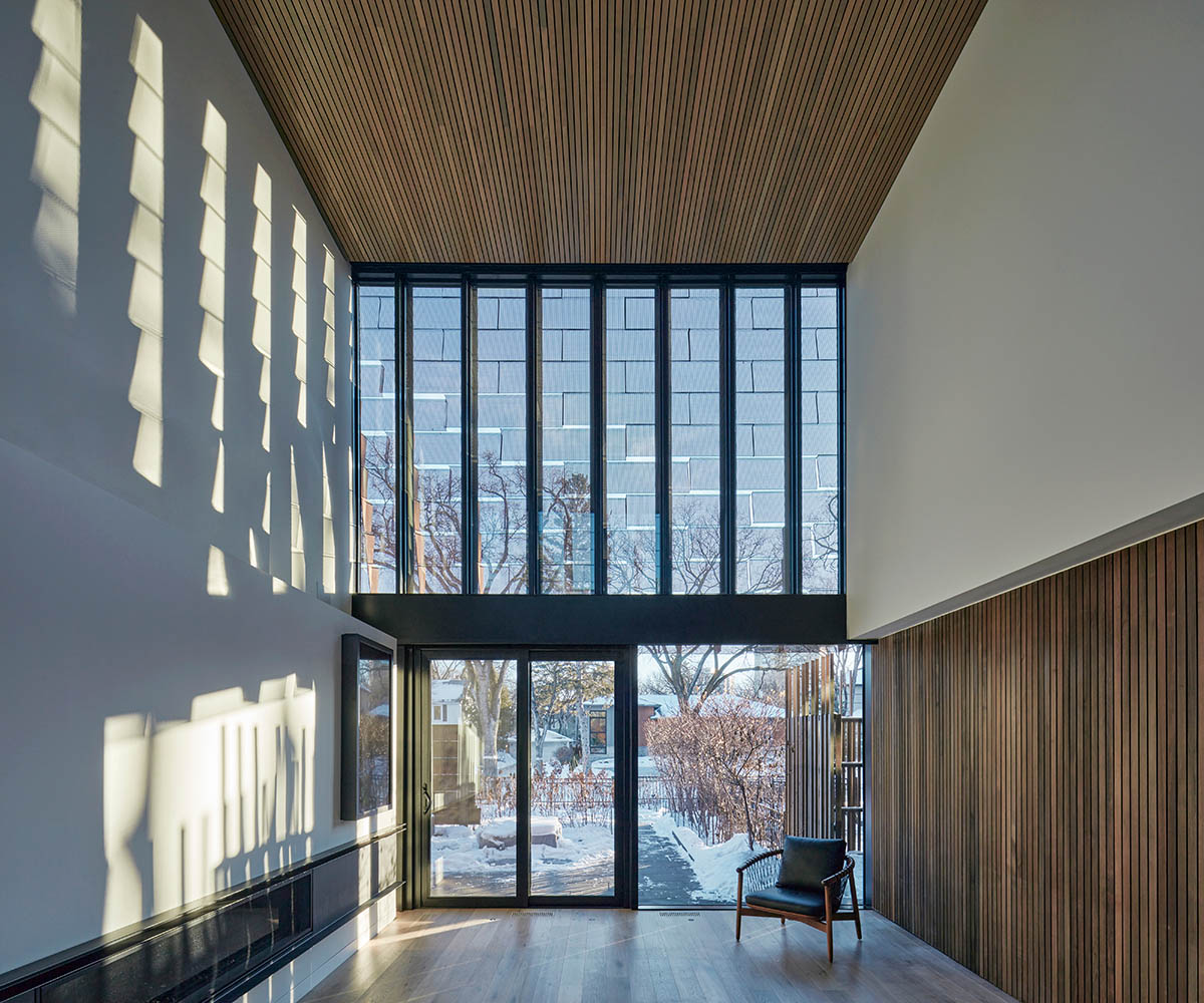Weathered steel weil wraps the façade of Veil House in to resist snowfalls in Winnipeg