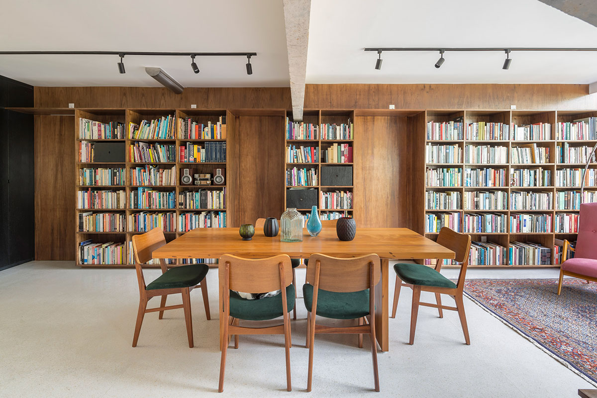 A historic Brazilian apartment has been redesigned with wooden bookcase as main divider