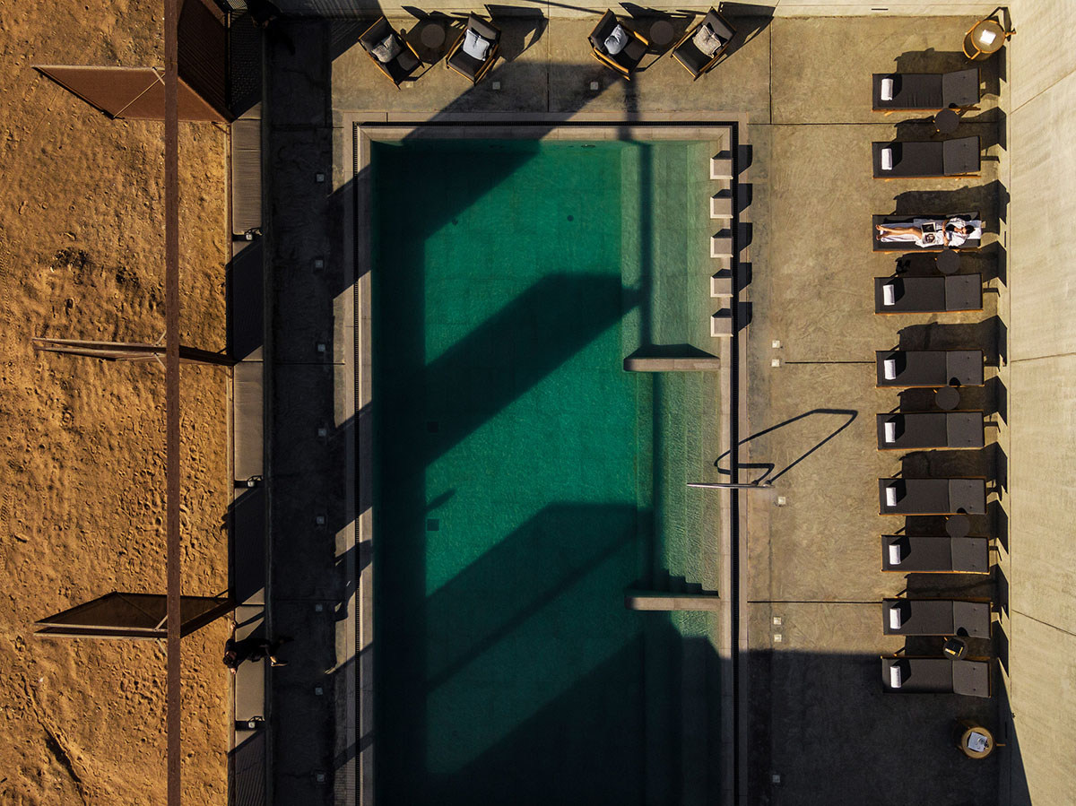 Anarchitect nestles this earth color hotel and spa building into the prehistoric of UAE